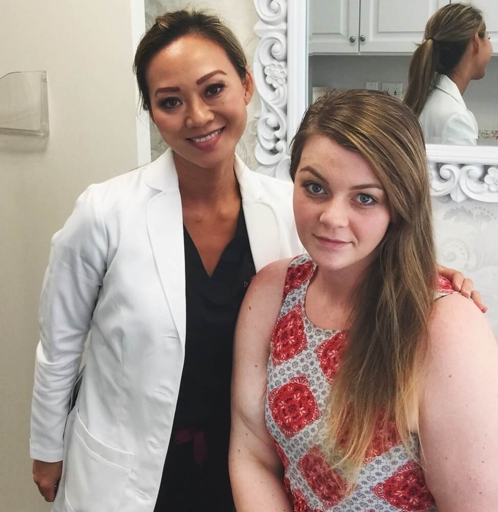 Dr. Cat posing with a patient during a consultation at her clinic