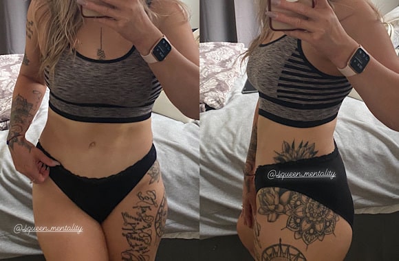 Woman in black athletic wear and baseball cap taking a side-view mirror selfie showcasing her toned body and tattoos.