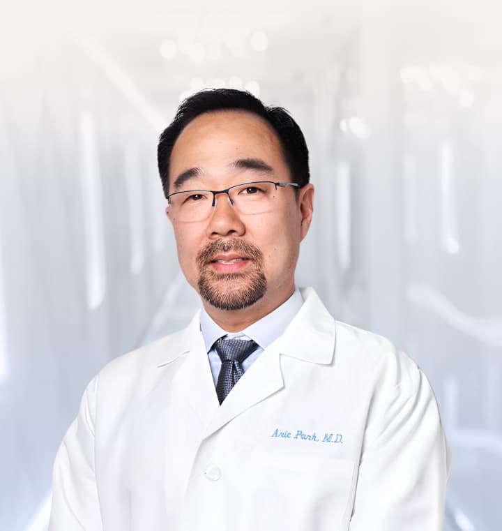 rofessional portrait of Dr. Park in a white medical coat.