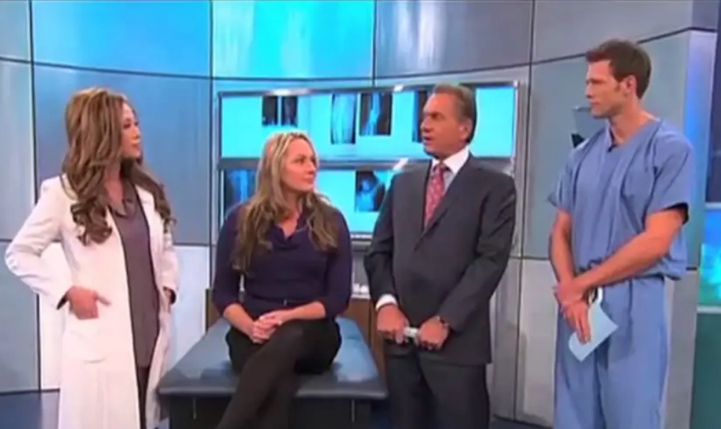 Dr. Cat in discussion with medical professionals and a patient on a television segment.