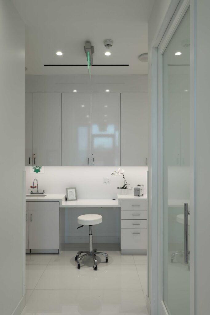 Prep area with sink, cabinets and a stool next to the operating room